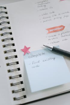 A notebook with handwritten to-do list, pastel sticky notes, and pen emphasizing productivity.