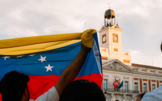 Venezuelan flag waving during a protest at Puerta del Sol, Madrid.
